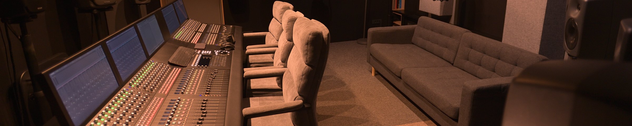 Side view of the mixing console, monitoring loudspeakers and client seating